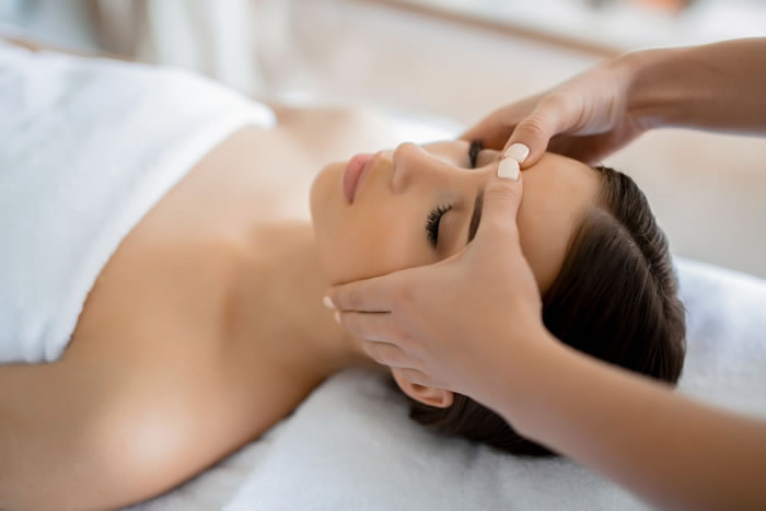woman getting a facial massage for rest and relaxation