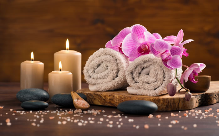 candles towels and hot stones are related to body massages near me