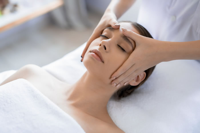 woman receiving facial massage to alleviate Temporomandibular Joint Syndrome